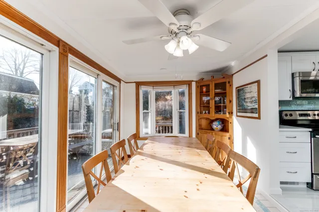 a large white kitchen with granite countertop a large window and a sink