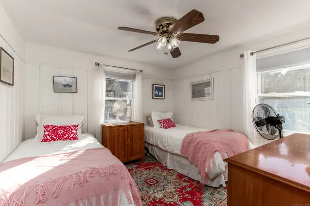 a bedroom with two beds and a window