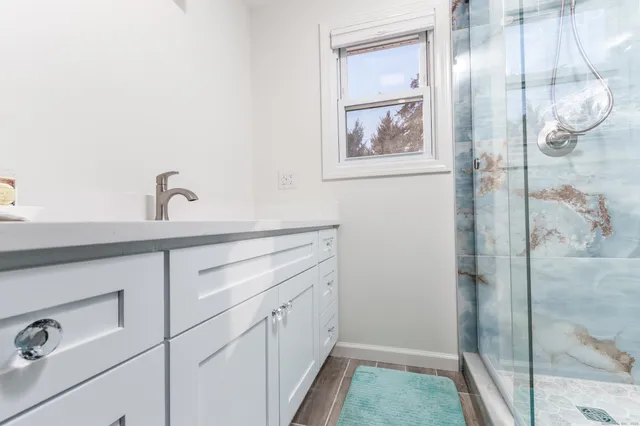 a bathroom with a sink and mirror