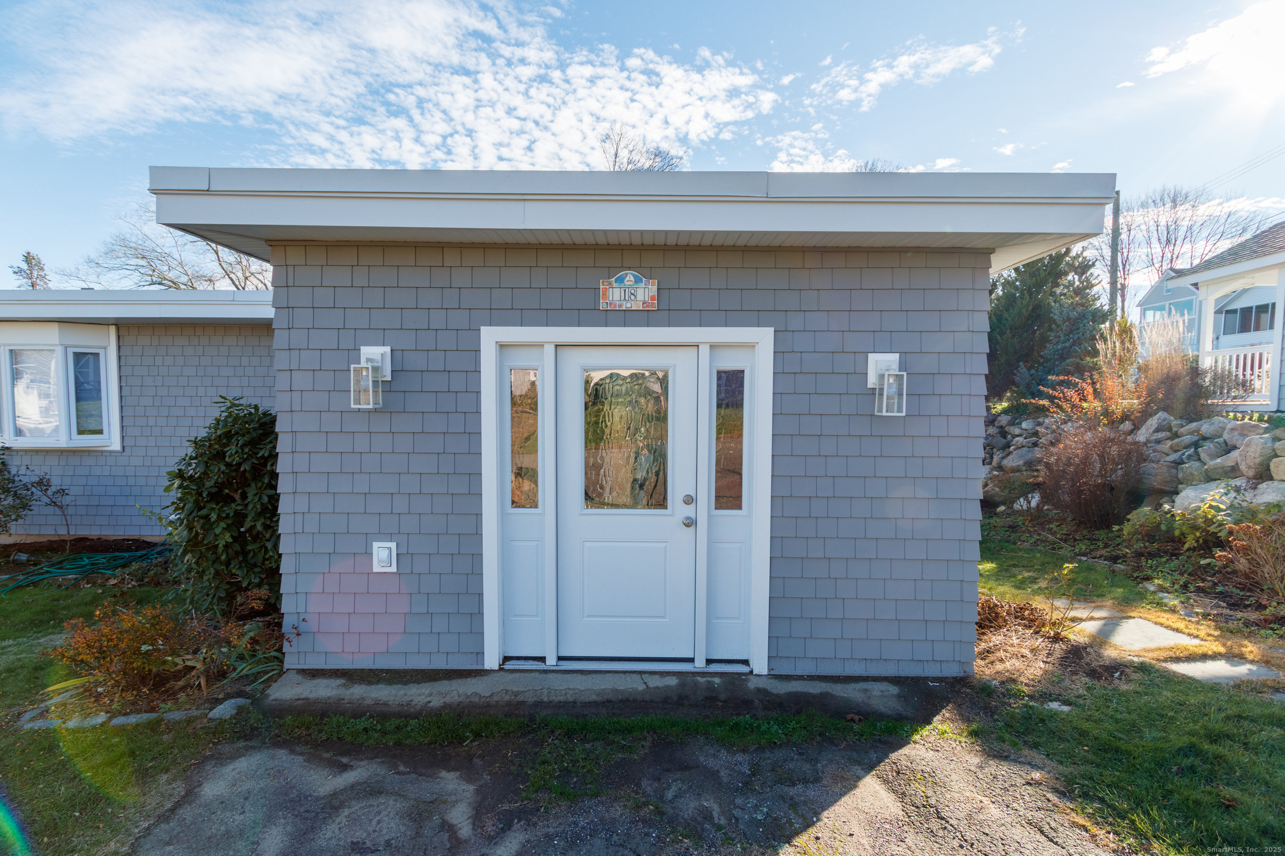 18 Bay Street Guilford, CT 06437 - Photo 3 of 34 a front view of a house with garden