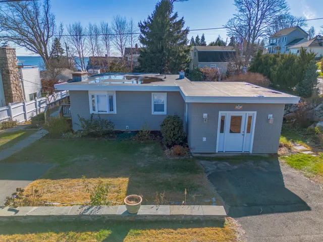 a front view of a house with a garden and yard