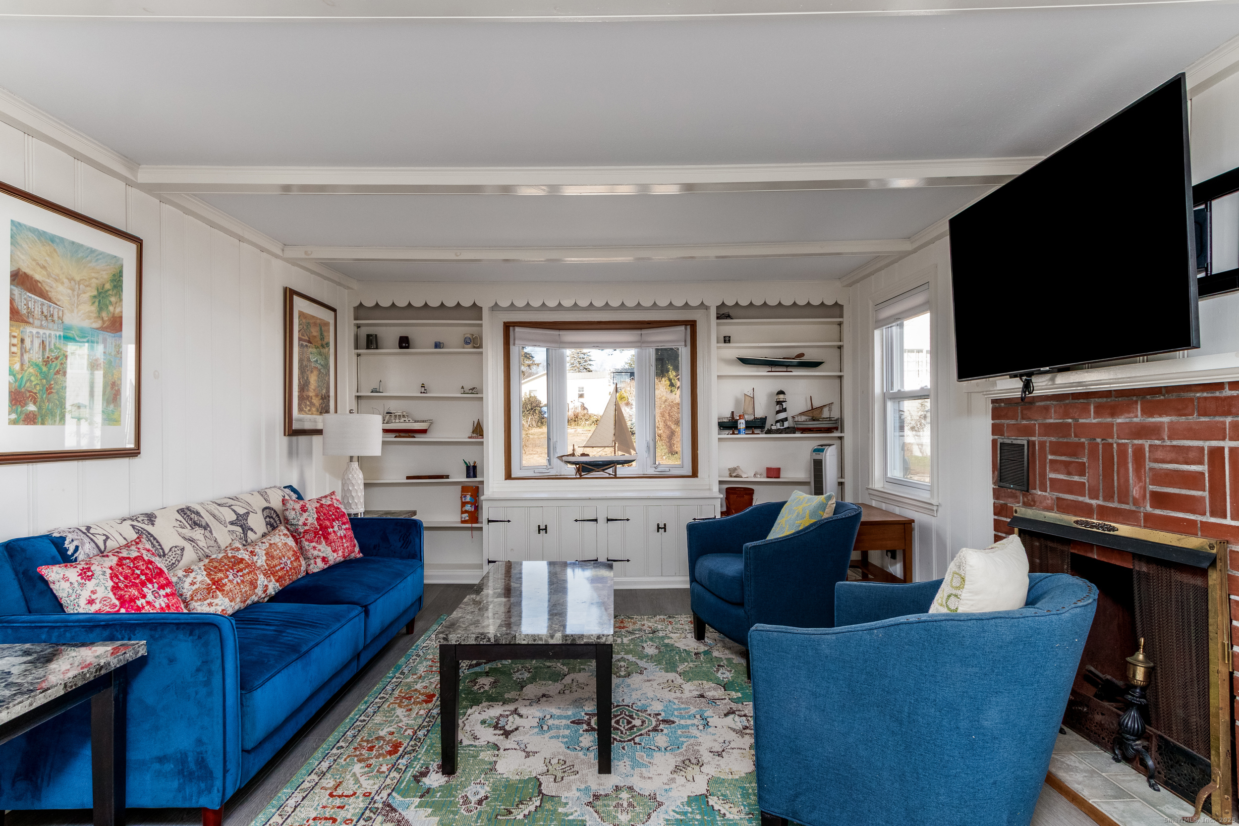18 Bay Street Guilford, CT 06437 - Photo 9 of 34 a living room with furniture and a flat screen tv