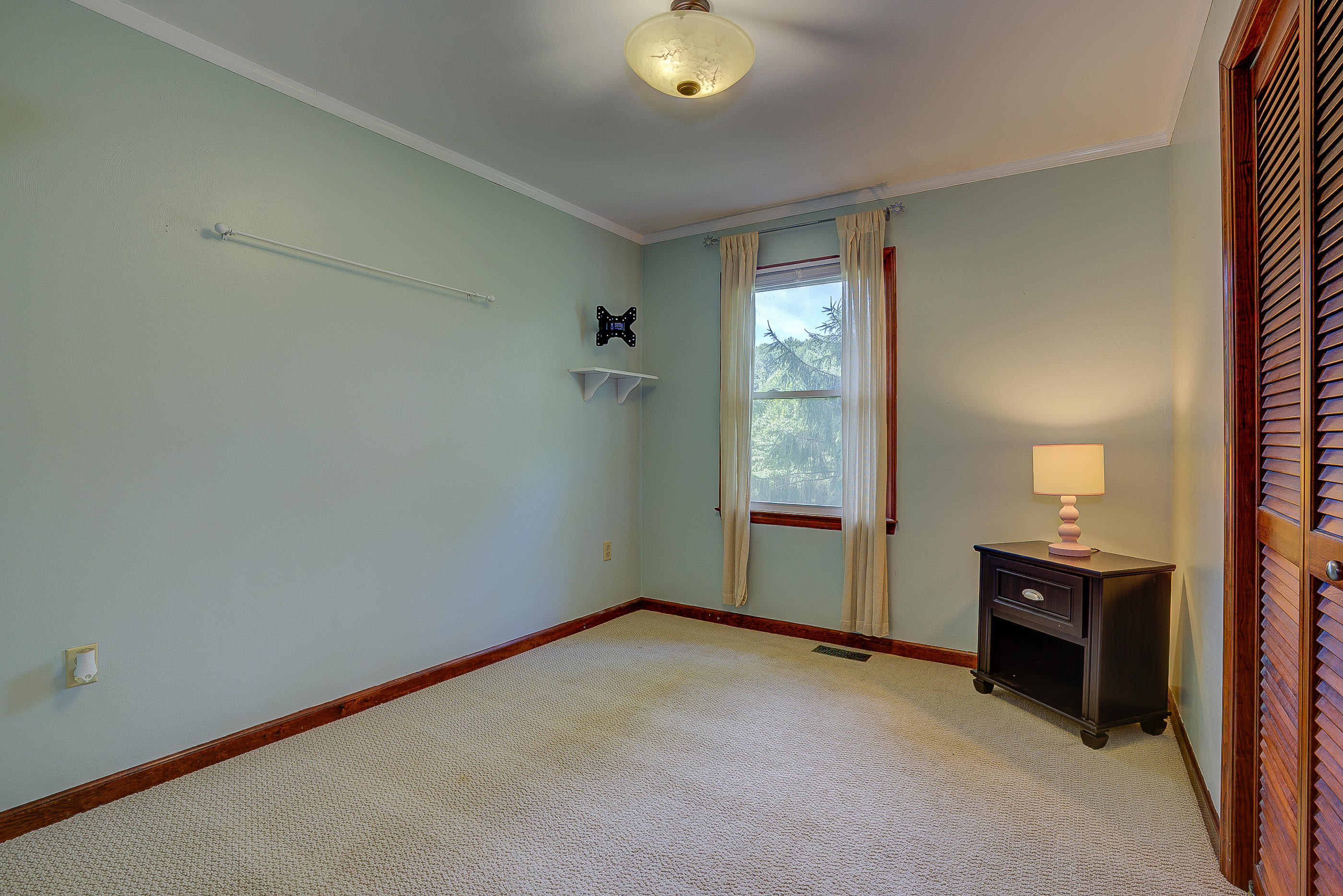 1405 Bore Auger Road Blue Ridge, VA 24064 - Photo 13 of 22 an empty room with closet and mirror