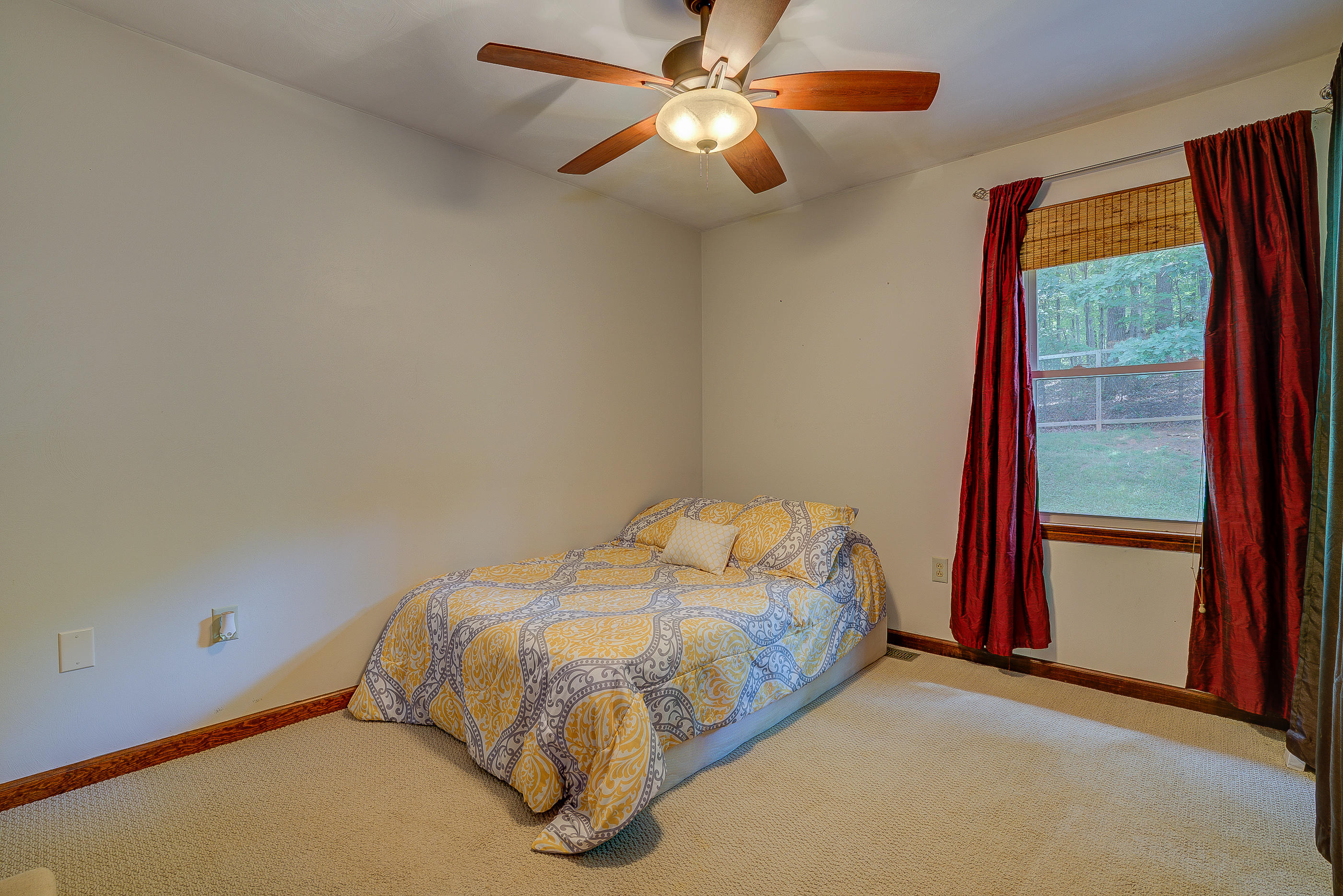 1405 Bore Auger Road Blue Ridge, VA 24064 - Photo 15 of 22 a bedroom with a bed and a large window