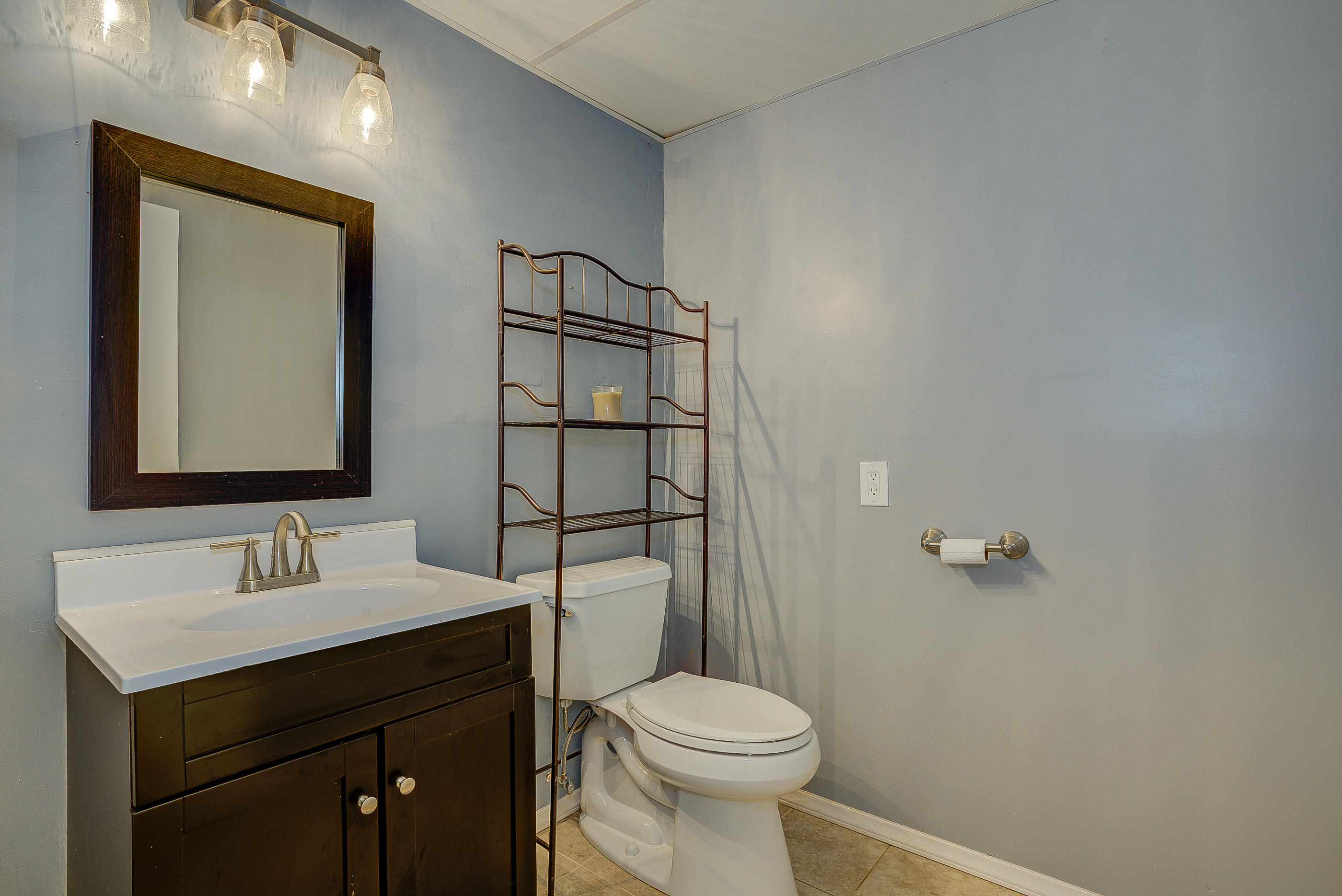 1405 Bore Auger Road Blue Ridge, VA 24064 - Photo 17 of 22 a bathroom with a toilet sink and mirror