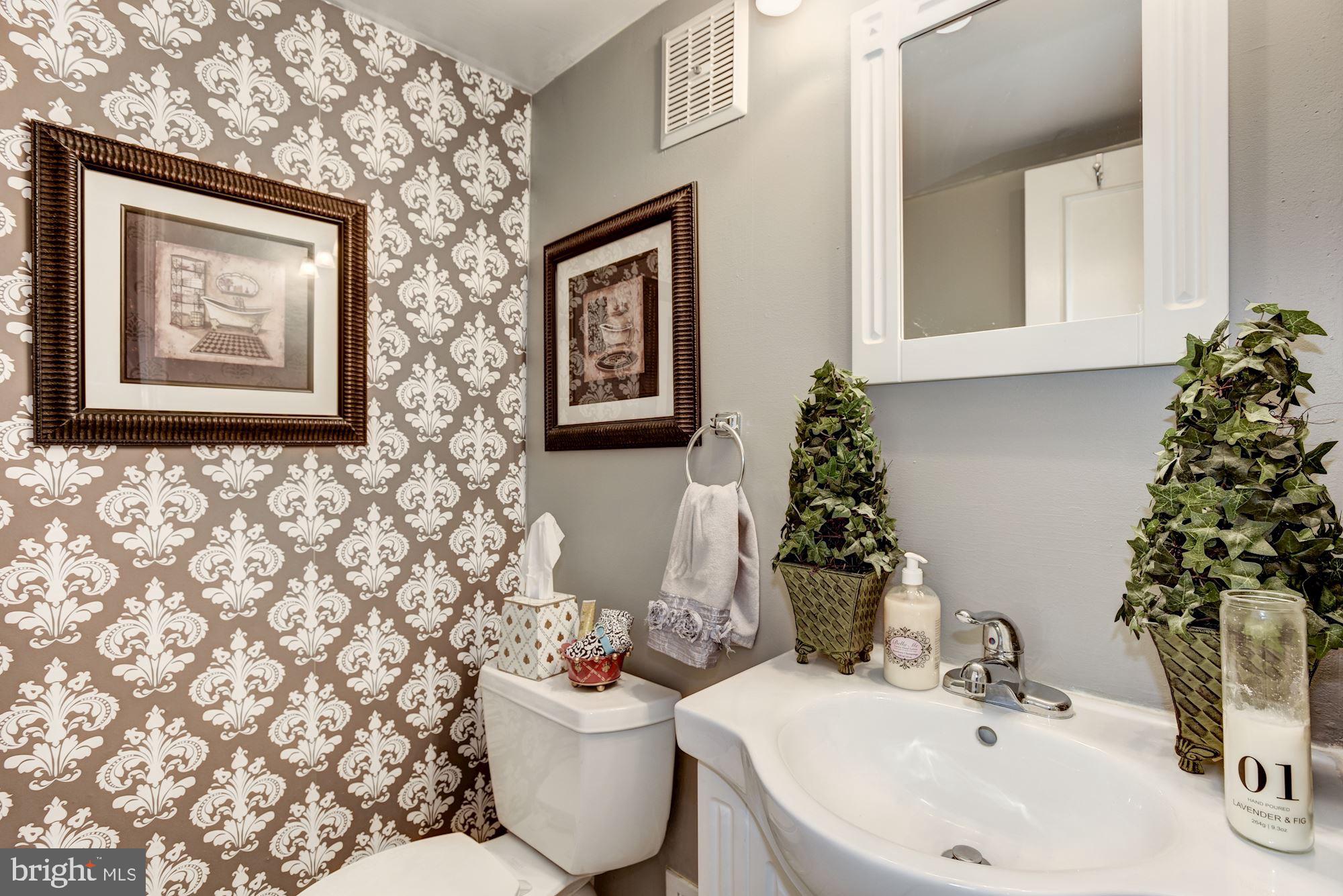 1851 Wainwright Drive Reston, VA 20190 - Photo 12 of 26 a bathroom with a sink and mirror with toilet