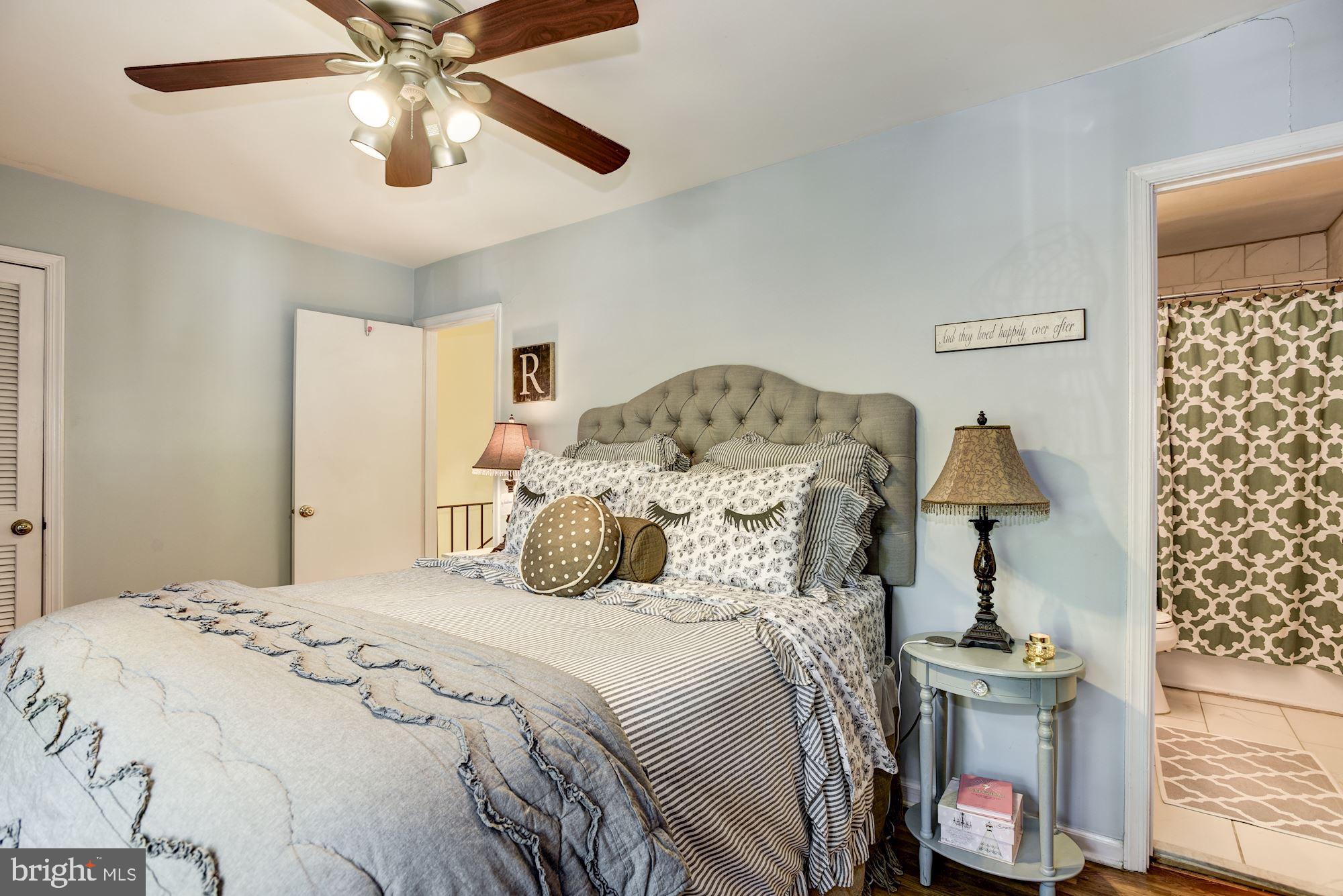 1851 Wainwright Drive Reston, VA 20190 - Photo 14 of 26 a bedroom with a bed and a chandelier