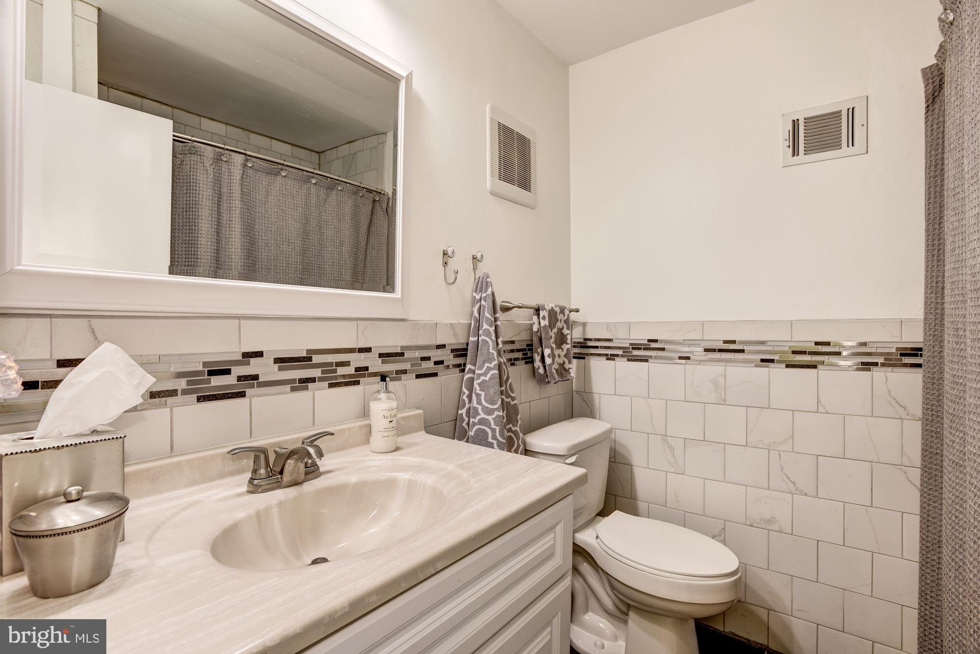1851 Wainwright Drive Reston, VA 20190 - Photo 18 of 26 a bathroom with a sink toilet and mirror