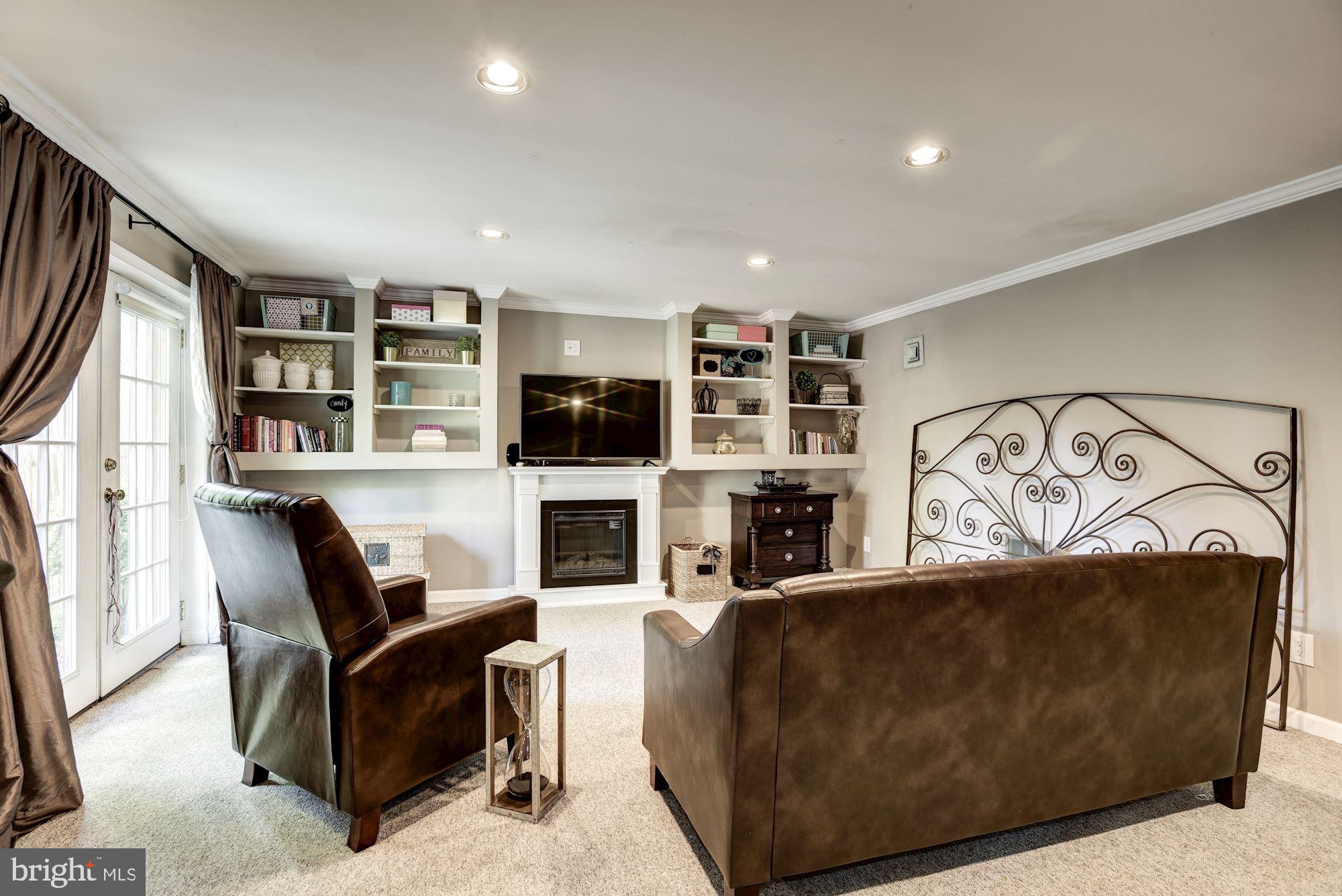 1851 Wainwright Drive Reston, VA 20190 - Photo 19 of 26 a living room with furniture a flat screen tv and a fireplace