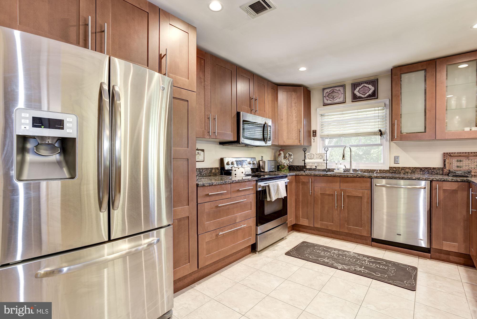 1851 Wainwright Drive Reston, VA 20190 - Photo 10 of 26 a kitchen with granite countertop a refrigerator stove top oven and sink