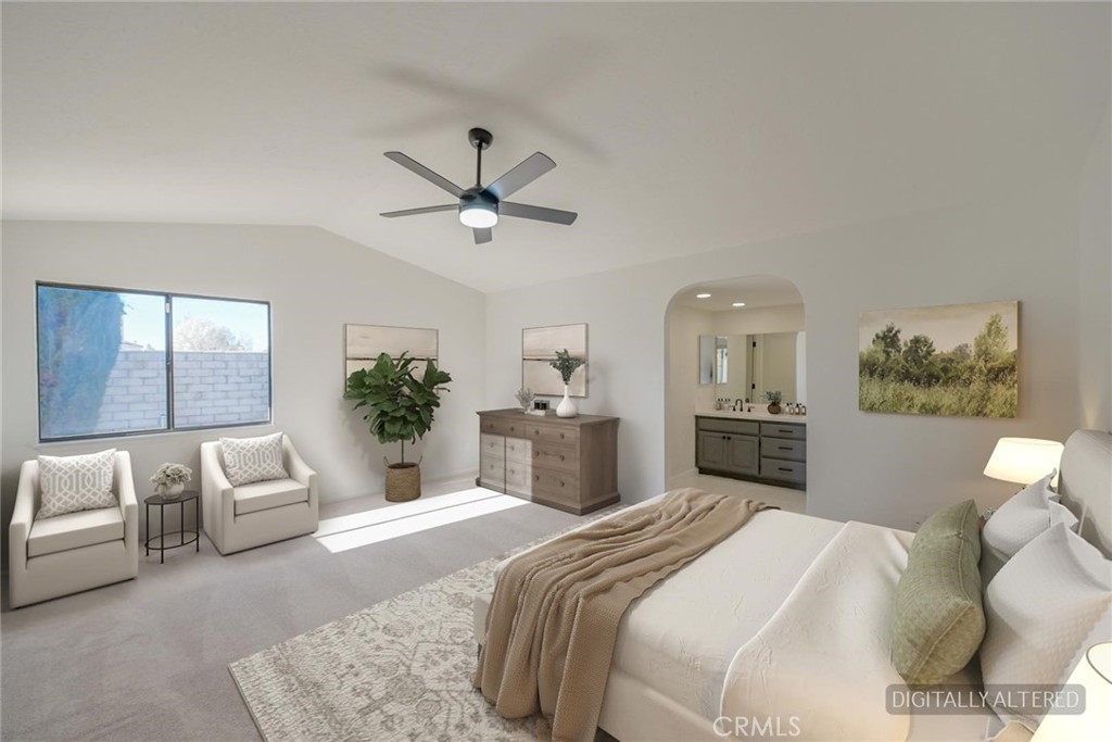 18515 Kalin Ranch Drive Victorville, CA 92395 - Photo 13 of 33 a bedroom with a bed a chandelier and a couch