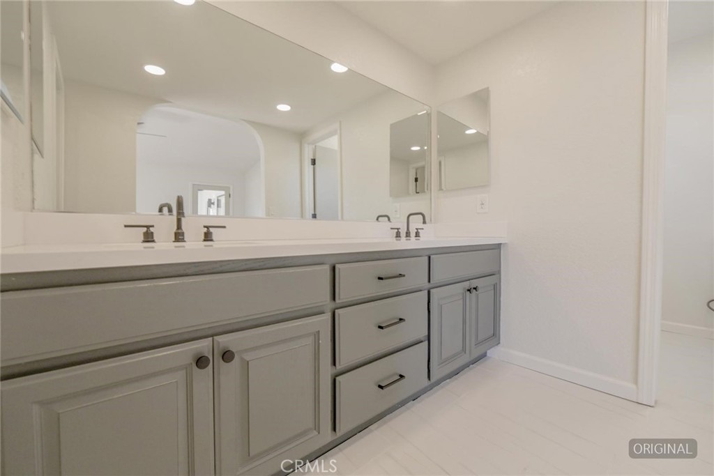 18515 Kalin Ranch Drive Victorville, CA 92395 - Photo 16 of 33 a bathroom with a double vanity sink and mirror