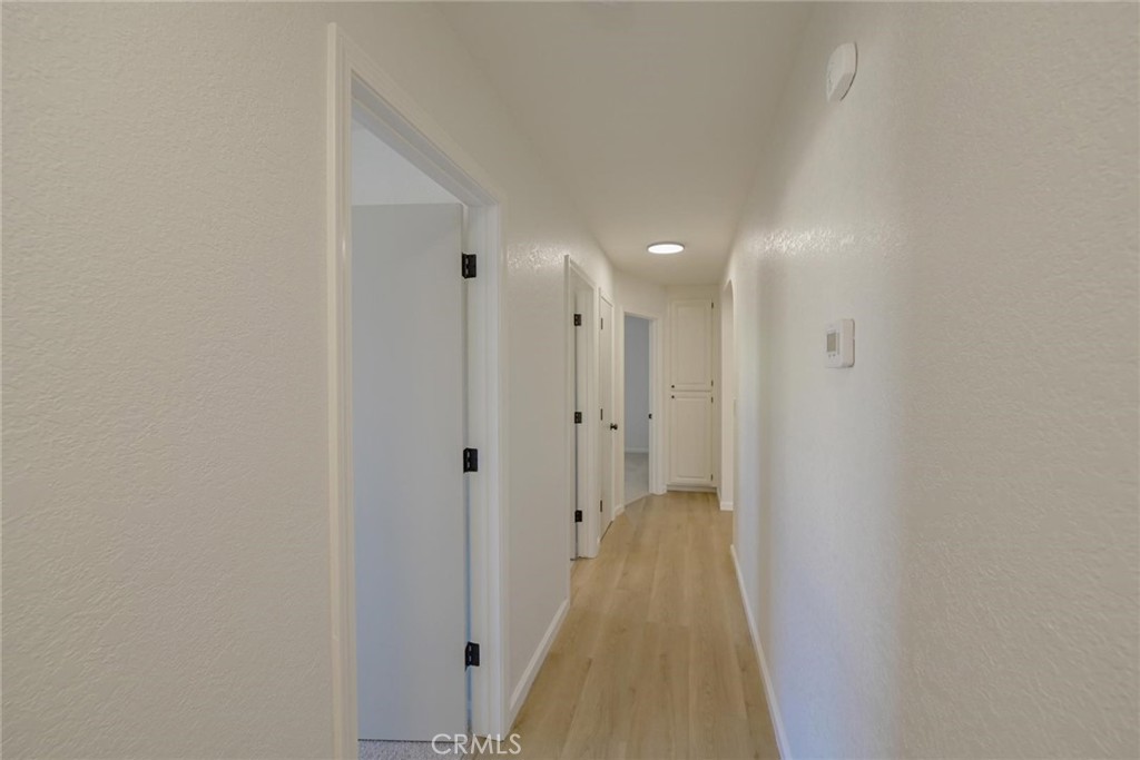 18515 Kalin Ranch Drive Victorville, CA 92395 - Photo 18 of 33 a view of a hallway with white walls