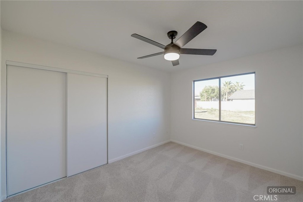 18515 Kalin Ranch Drive Victorville, CA 92395 - Photo 20 of 33 an empty room with a window and a fan