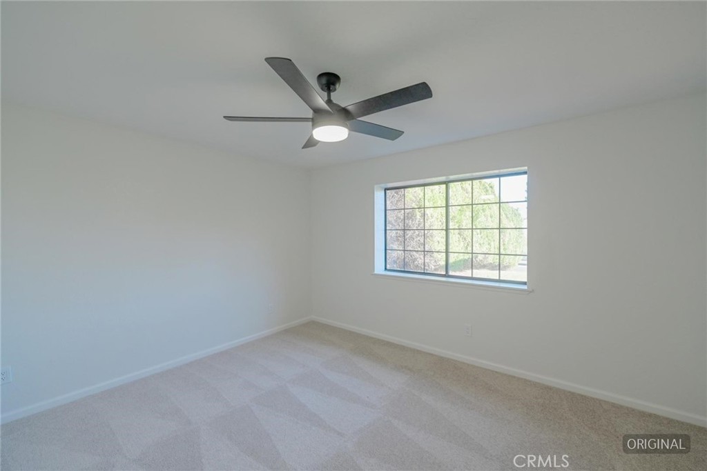 18515 Kalin Ranch Drive Victorville, CA 92395 - Photo 24 of 33 an empty room with a window and a fan