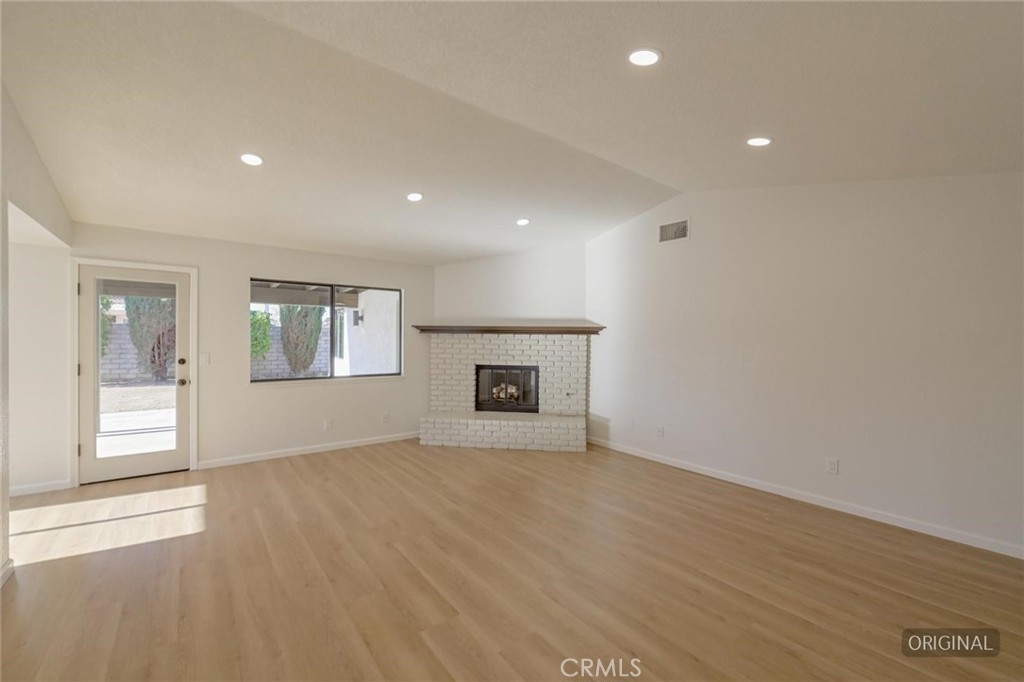 18515 Kalin Ranch Drive Victorville, CA 92395 - Photo 5 of 33 an empty room with windows and fireplace