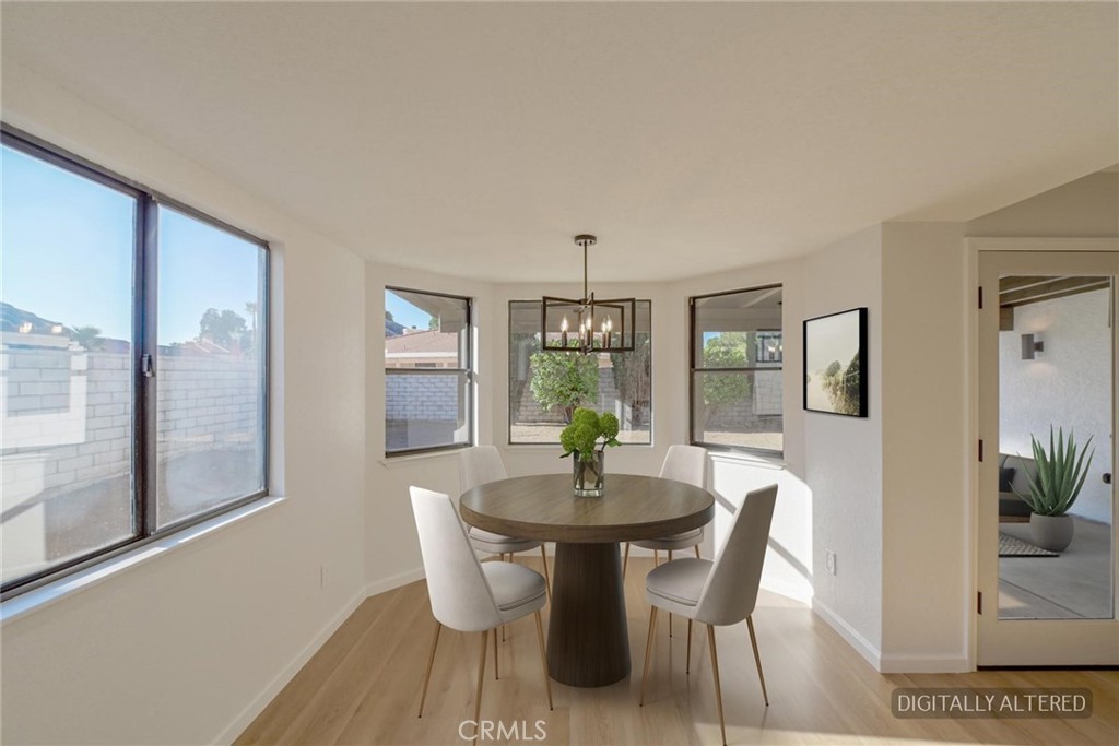 18515 Kalin Ranch Drive Victorville, CA 92395 - Photo 6 of 33 a dining room with furniture wooden floor and a potted plant