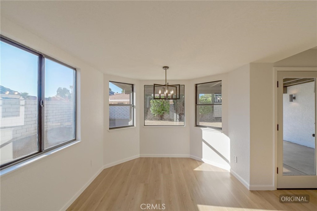 18515 Kalin Ranch Drive Victorville, CA 92395 - Photo 7 of 33 wooden floor in an empty room with a window
