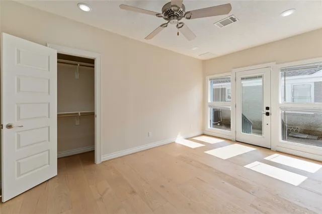 a view of an empty room with a fireplace and a window