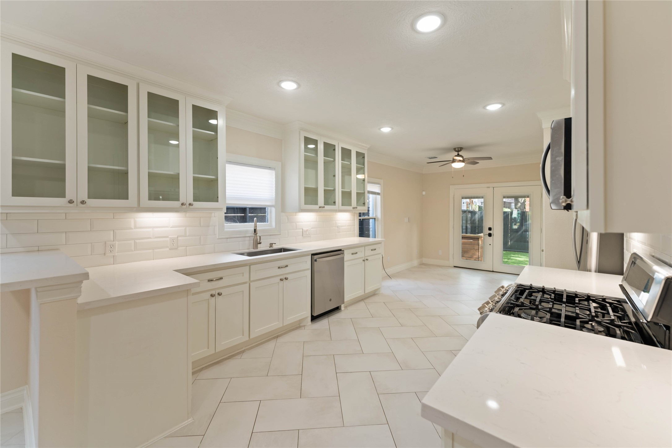 2631 Persa Street Houston, TX 77098 - Photo 22 of 25 a large white kitchen with a large window