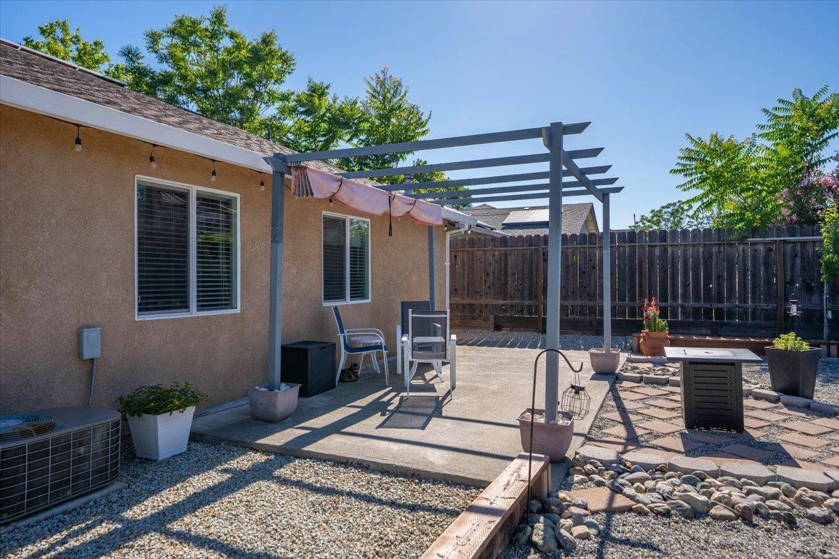 2110 Gentry Way Red Bluff, CA 96080 - Photo 42 of 47 a view of a patio with couches chairs potted plants and floor to ceiling window and potted plants