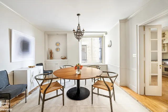 a spacious bedroom with a bed and wooden floor