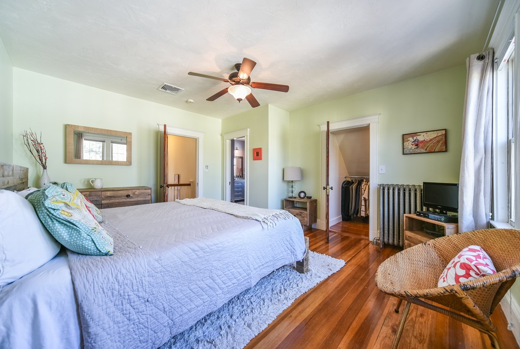 99 Parkton Road, Unit 2 Boston, MA 02130 - Photo 14 of 19 a spacious bedroom with a bed and a chandelier