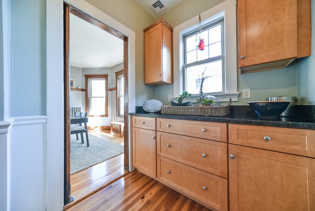 99 Parkton Road, Unit 2 Boston, MA 02130 - Photo 9 of 19 a kitchen with stainless steel appliances granite countertop a sink stove and cabinets