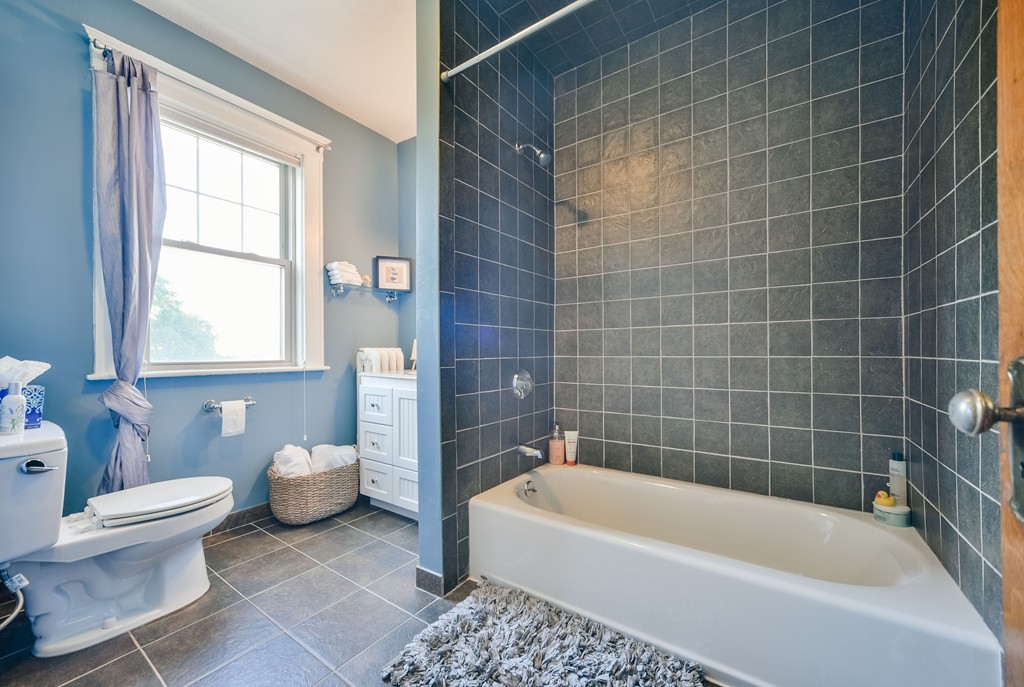 99 Parkton Road, Unit 2 Boston, MA 02130 - Photo 10 of 19 a white bath tub sitting next to a white toilet and a window