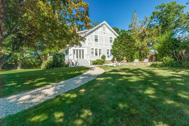 9 Contentment Island Road Darien, CT 06820 - Photo 3 of 38 a view of a house with a big yard and large trees