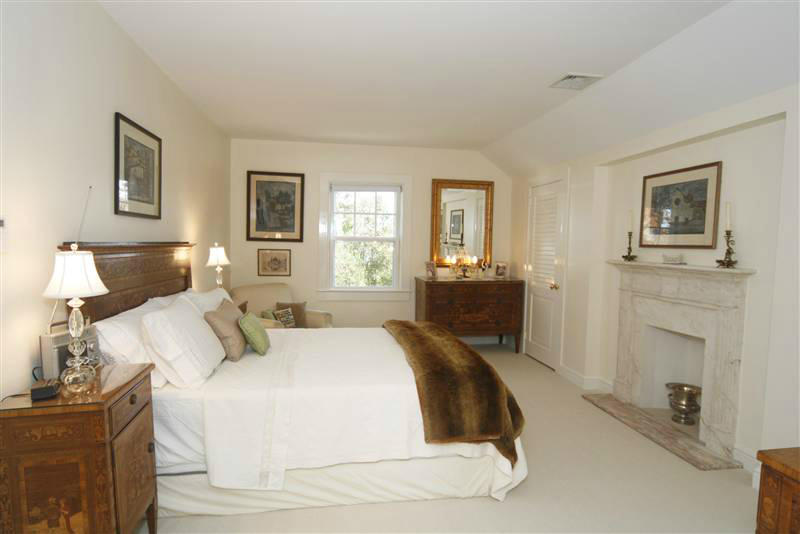 9 Contentment Island Road Darien, CT 06820 - Photo 32 of 38 a spacious bedroom with a bed and a cabinets