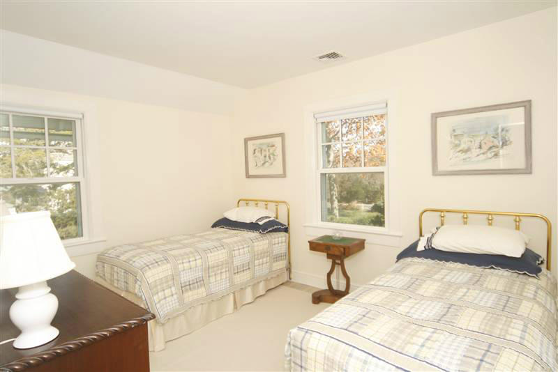 9 Contentment Island Road Darien, CT 06820 - Photo 35 of 38 a bedroom with a bed and window