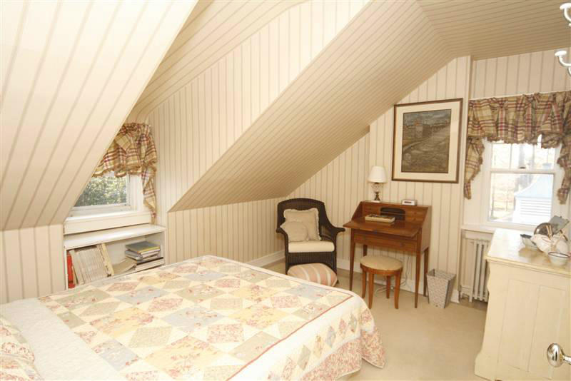 9 Contentment Island Road Darien, CT 06820 - Photo 37 of 38 a bedroom with a bed and wooden floor