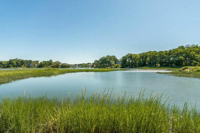 9 Contentment Island Road Darien, CT 06820 - Photo 5 of 38 a view of a lake with a big yard and large trees