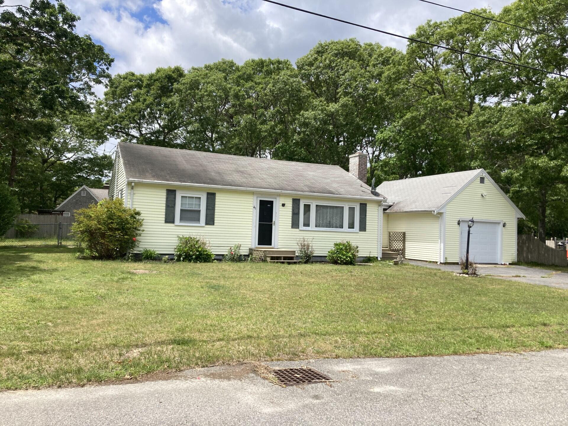 45 Blue Jay Drive Hyannis, MA 02601 - Photo 1 of 18 a front view of a house with a garden