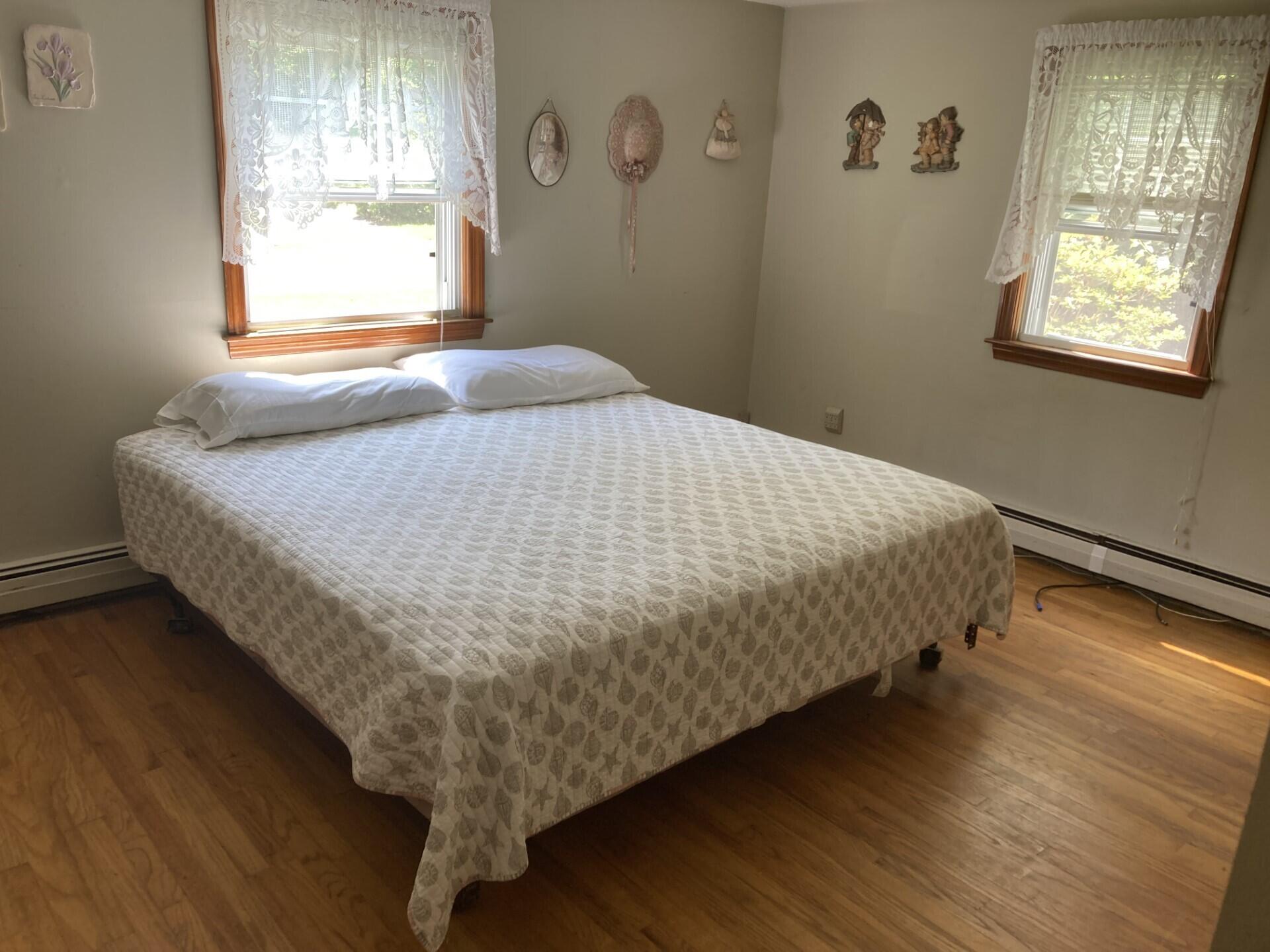 45 Blue Jay Drive Hyannis, MA 02601 - Photo 18 of 18 a bed sitting in a bedroom next to a window