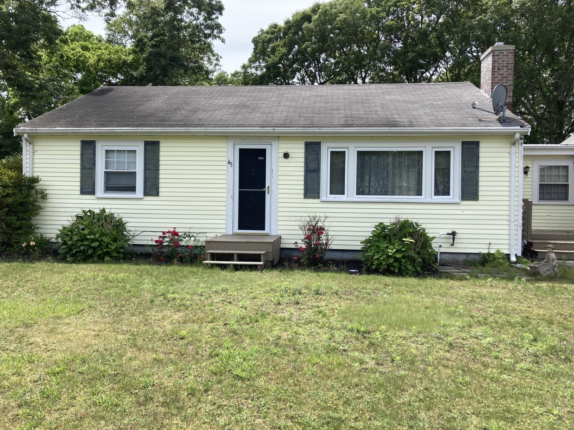 45 Blue Jay Drive Hyannis, MA 02601 - Photo 2 of 18 a front view of a house with garden