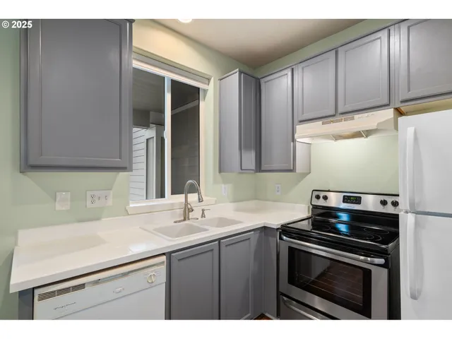 a kitchen with a sink stove and cabinets