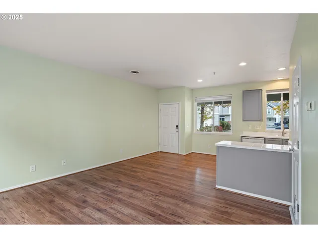 a view of kitchen and hall with wooden floor