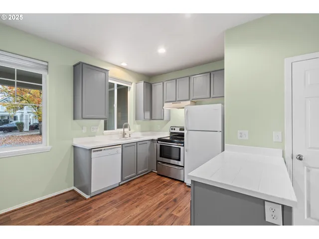 a kitchen with a refrigerator sink and stove