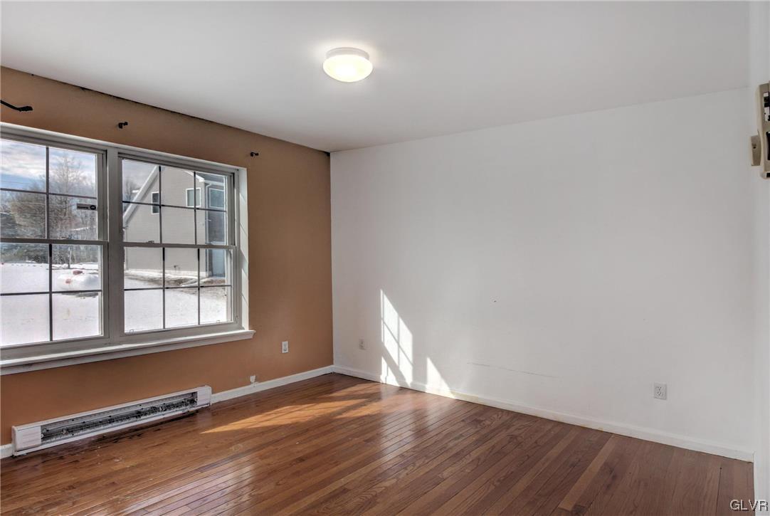 1095 Clover Road South Long Pond, PA 18334 - Photo 19 of 27 an empty room with wooden floor and windows