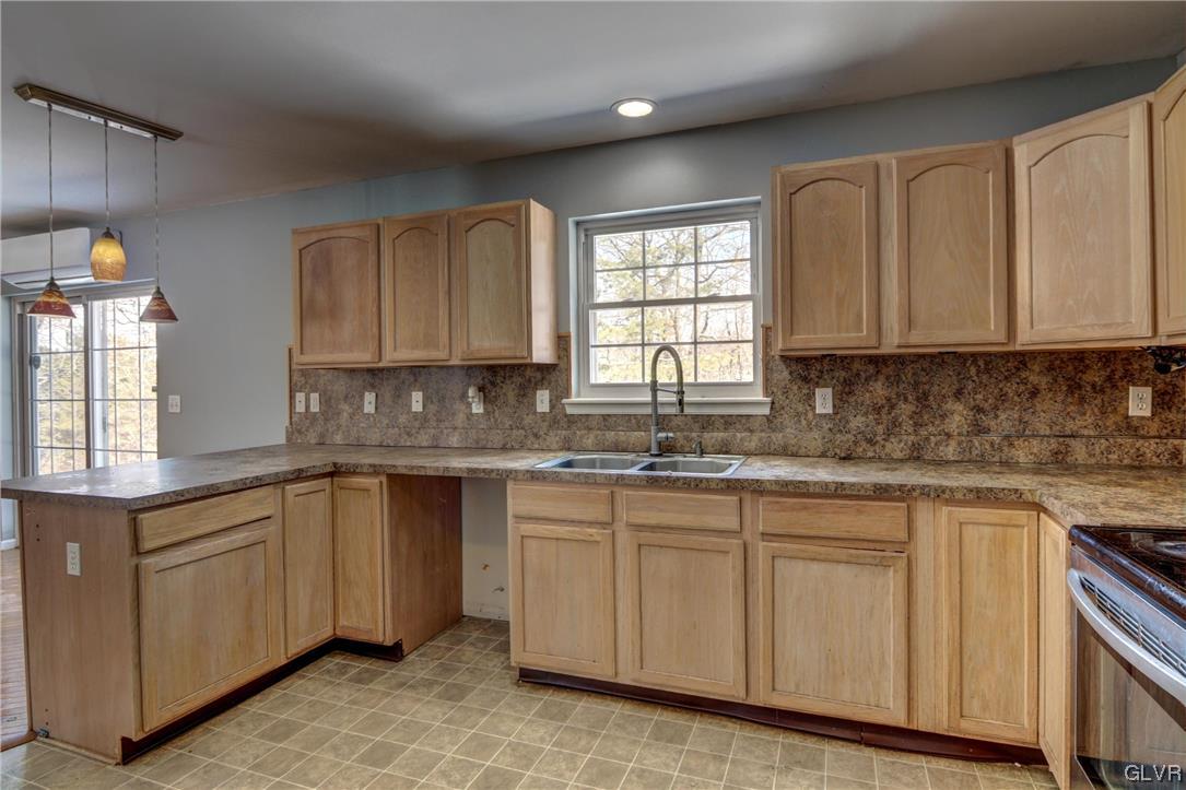 1095 Clover Road South Long Pond, PA 18334 - Photo 6 of 27 a kitchen with granite countertop white cabinets sink and window