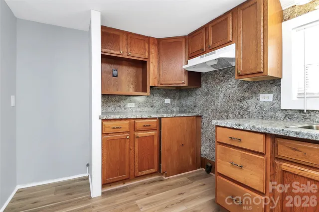 a kitchen with stainless steel appliances granite countertop a sink and a granite counter tops