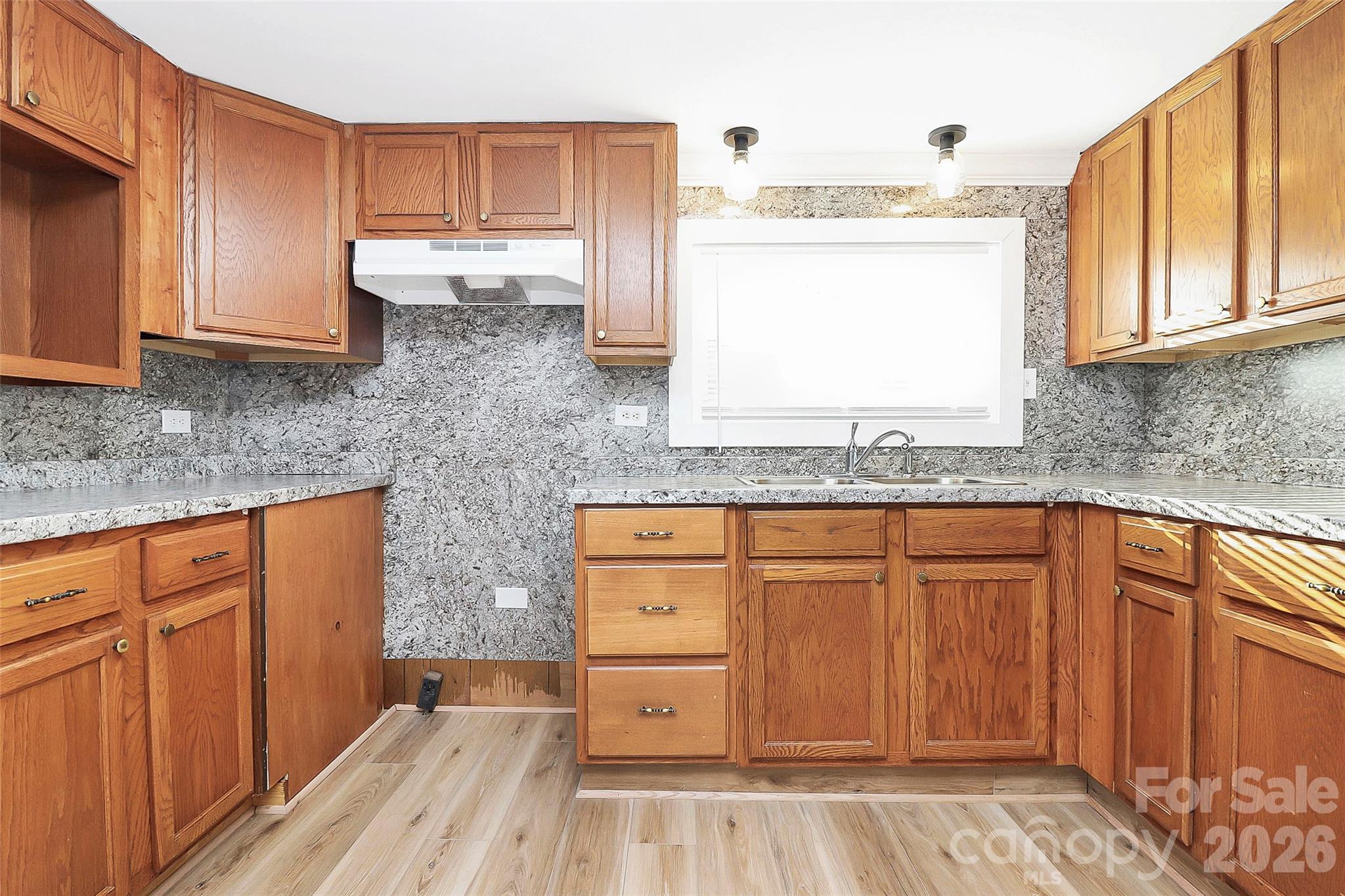 146 Swink Street Southwest Concord, NC 28027 - Photo 14 of 35 a kitchen with granite countertop wooden cabinets stainless steel appliances a sink and a window