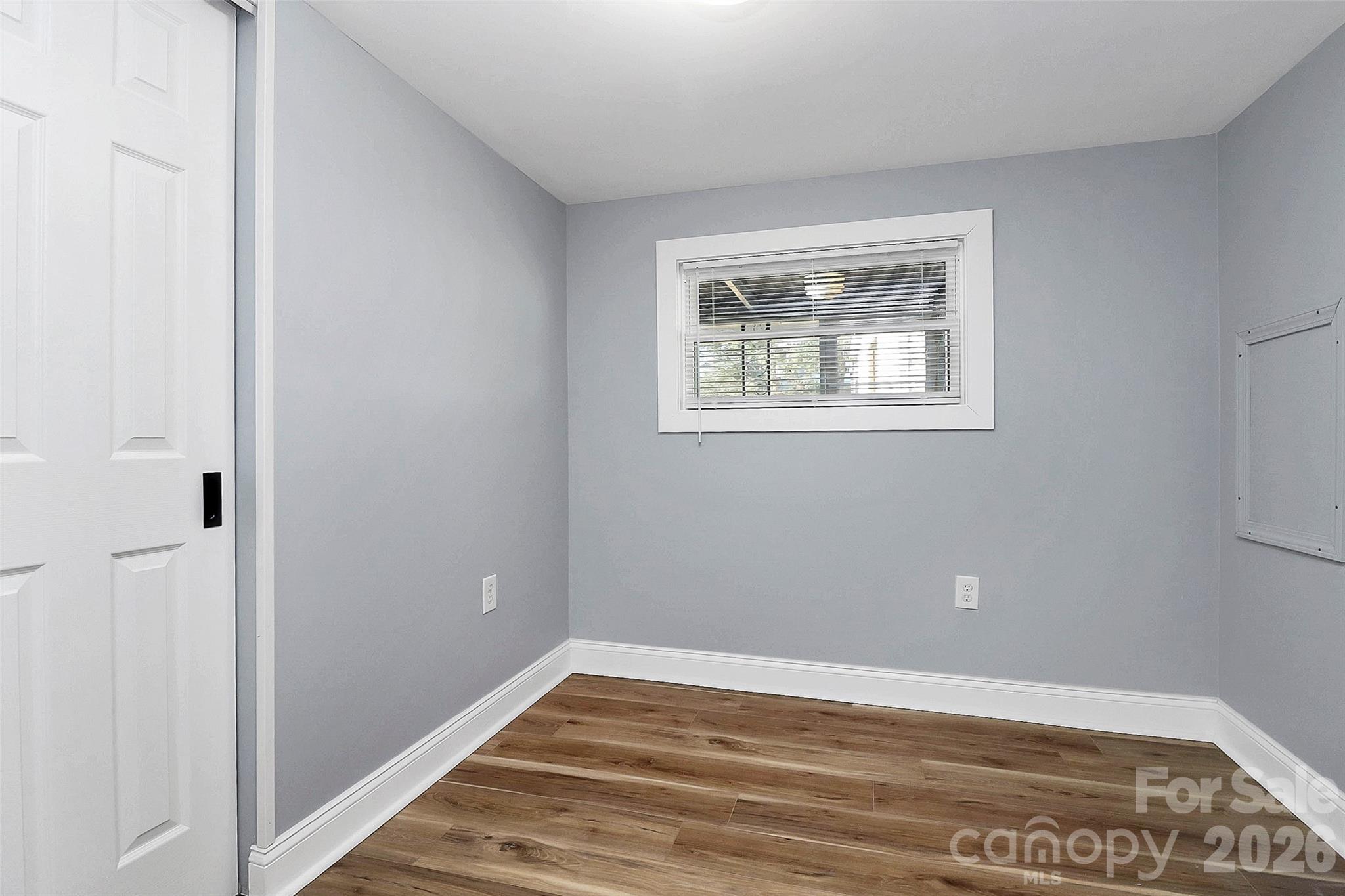 146 Swink Street Southwest Concord, NC 28027 - Photo 15 of 35 a view of an empty room with wooden floor and a window