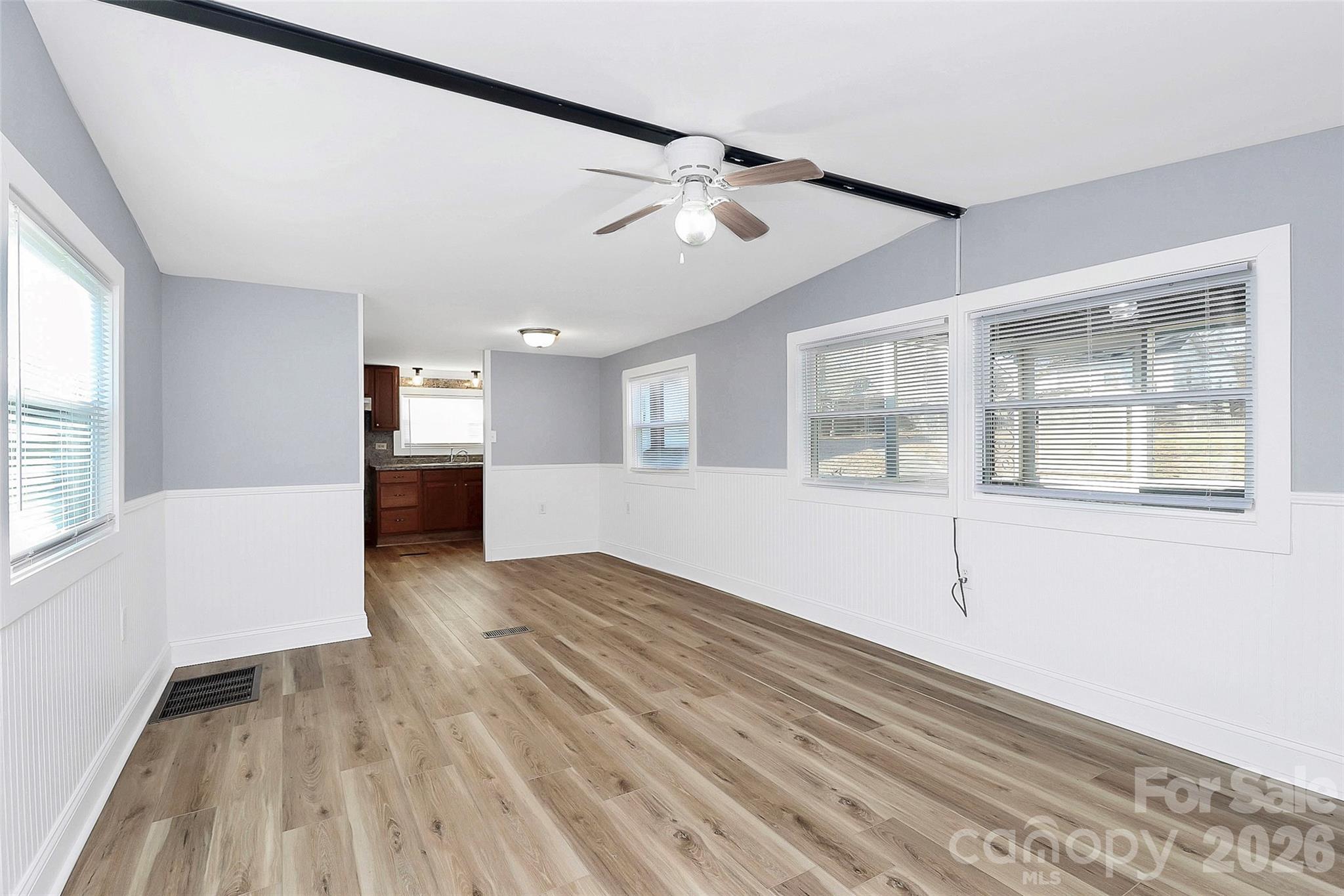 146 Swink Street Southwest Concord, NC 28027 - Photo 4 of 35 a view of empty room with wooden floor and windows