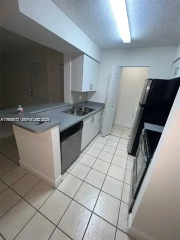 a kitchen with appliances and cabinets