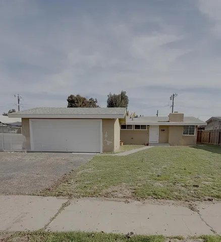 a view of a house with a yard and garage