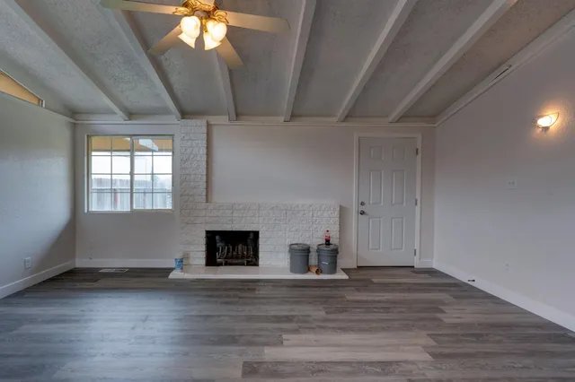 a view of a room with wooden floor