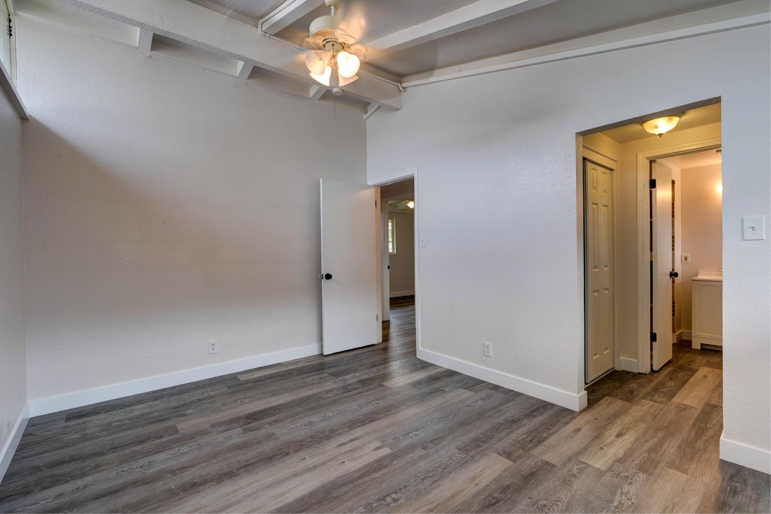 2310 Linden Street Atwater, CA 95301 - Photo 22 of 32 an empty room with wooden floor and a ceiling fan